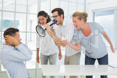 Casual business team shouting at a colleague