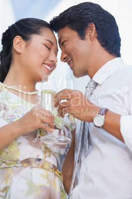 Happy couple having champagne together