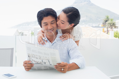 Couple reading a newspaper together