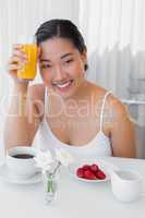 Happy woman having a healthy breakfast