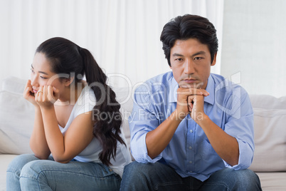 Couple not talking after a dispute on the sofa