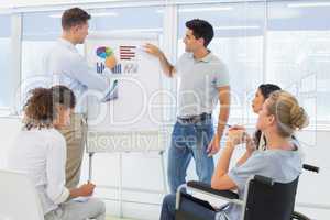 Casual businessmen giving presentation to colleagues