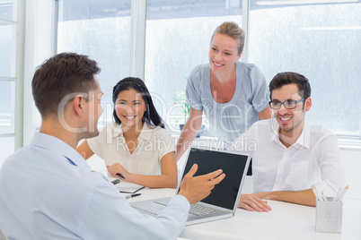 Casual businessman using laptop during meeting