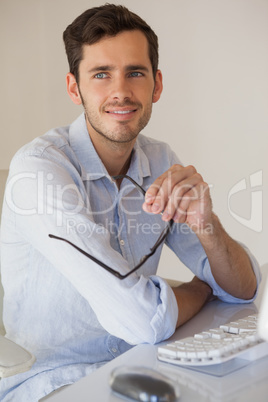 Casual businessman thinking at his desk