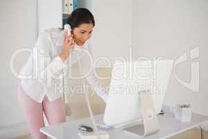 Casual businesswoman answering the phone