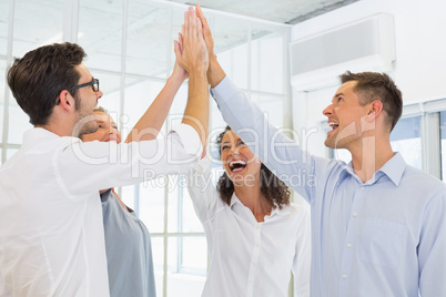 Casual business team high fiving