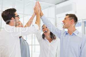 Casual business team high fiving