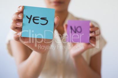 Casual businesswoman showing yes card