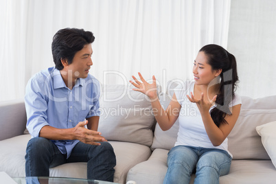 Couple having a dispute on the sofa