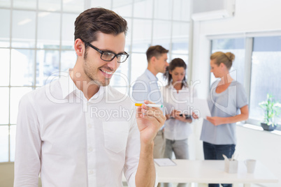 Casual businessman smiling at his electronic cigarette