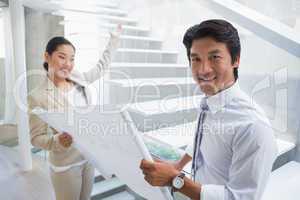 Estate agent showing stairs to potential buyer