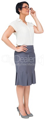 Thoughtful brown haired businesswoman in skirt