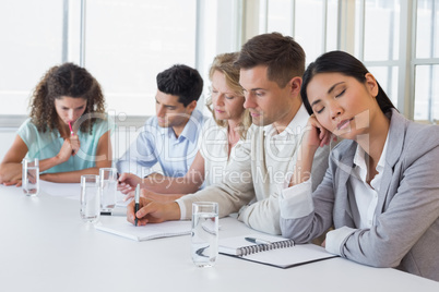 Casual businesswoman falling asleep during meeting