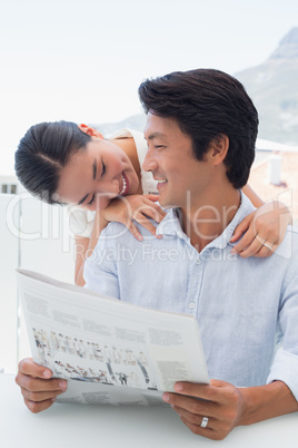 Couple reading a newspaper together