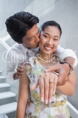 Couple showing engagement ring on womans finger