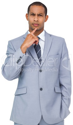 Thinking young businessman in blue suit