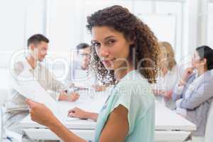 Casual businesswoman looking at camera during meeting