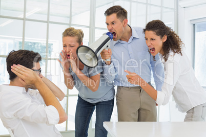Casual business team shouting at a colleague