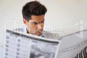 Casual businessman reading the newspaper