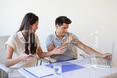 Casual business team working together at desk