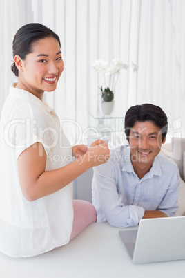 Happy couple using laptop together