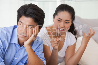 Couple sitting on the couch having a fight