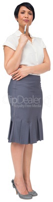 Thoughtful brown haired businesswoman in skirt