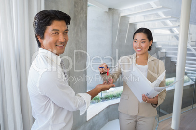 Estate agent giving house key to buyer