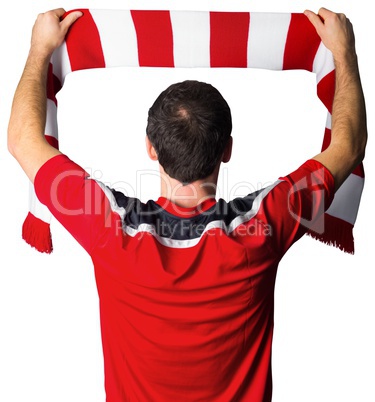 Football fan in red holding scarf