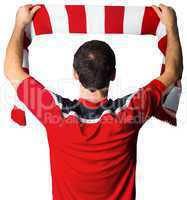 Football fan in red holding scarf