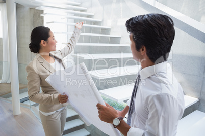 Estate agent showing stairs to potential buyer