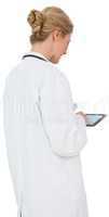 Blonde doctor in lab coat using tablet pc