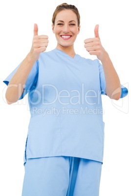 Pretty surgeon in blue scrubs giving thumbs up