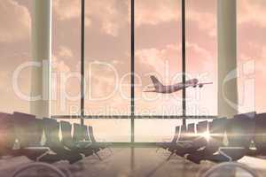 Airplane flying past departures lounge window