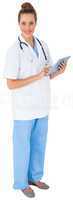 Pretty nurse in tunic using tablet pc