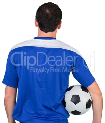 Football fan in blue holding ball