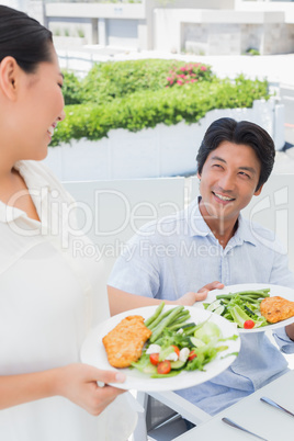 Woman serving a meal for her boyfriend
