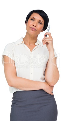 Thoughtful brown haired businesswoman in skirt