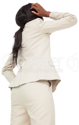 Thinking businesswoman in cream suit