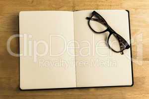 Overhead of reading glasses with notebook