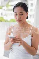 Asian woman texting on phone