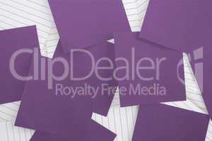 Purple paper strewn over notepad
