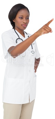 Young nurse in tunic pointing