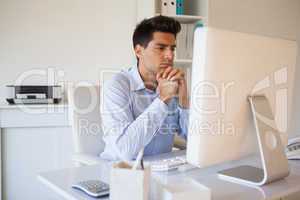 Casual businessman sitting at his desk