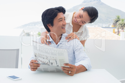 Couple reading a newspaper together