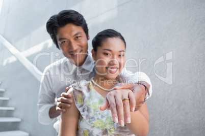 Couple showing engagement ring on womans finger