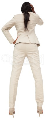 Thinking businesswoman in cream suit