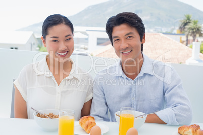 Smiling couple having breakfast together