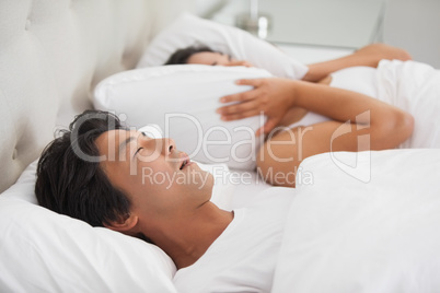 Woman covering her ears as partner is snoring loudly