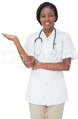 Young nurse in tunic presenting